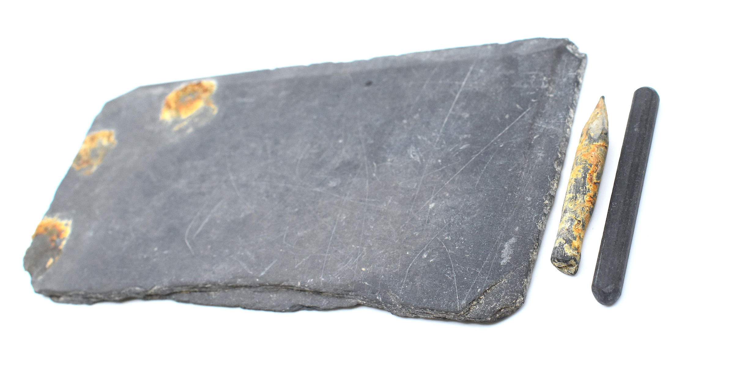 Image showing an old fragment of a writing slate with two slate pencil fragments alongside.