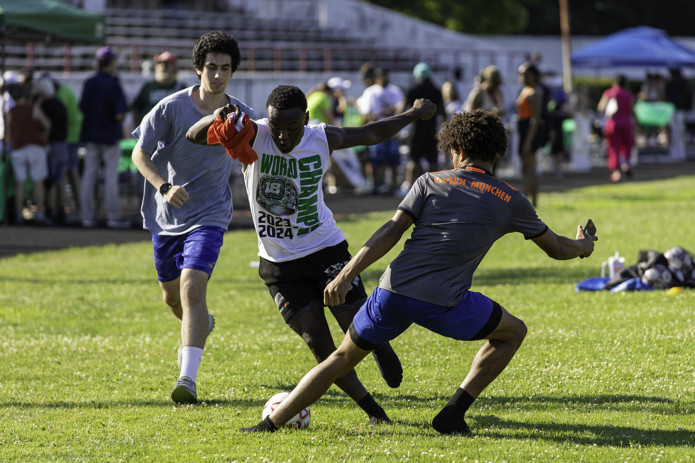 Three soccer players on the field at White Stadium 