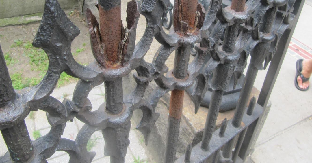 The decorative elements on this gate have almost totally rusted off. 