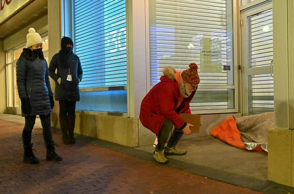 Mayor Wu listens as Assistant Director Jim Greene of Supportive Housing at MOH interviews a homeless Bostonian in the Downtown Crossing.