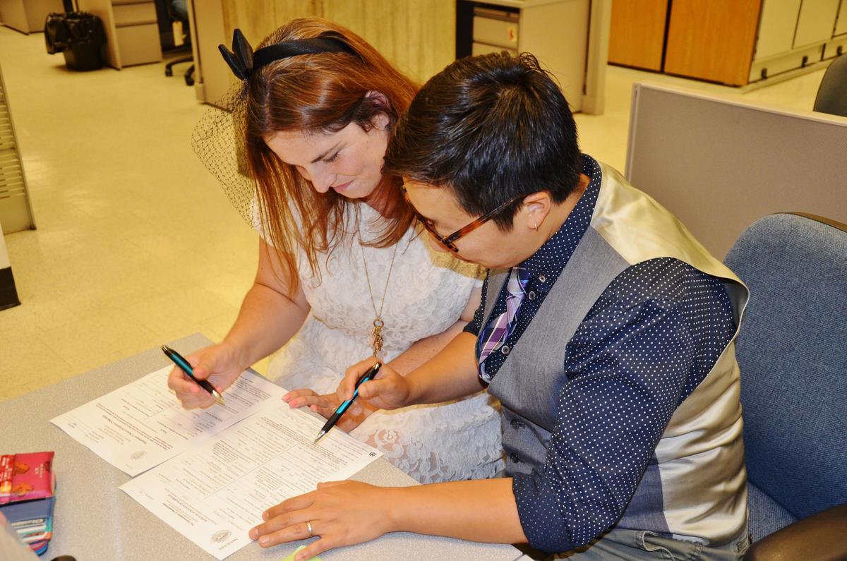 a couple filling out their marriage license