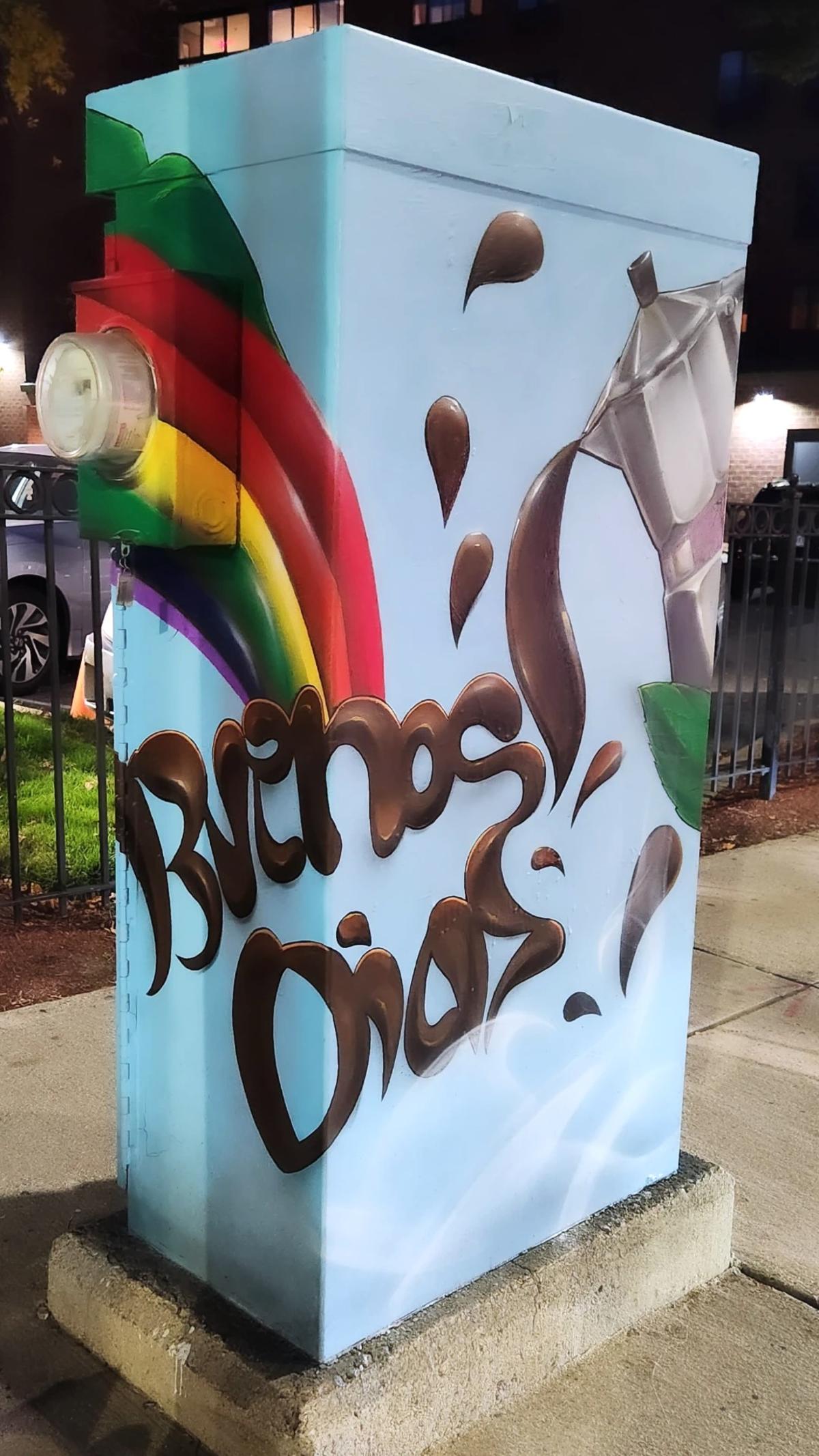 Painted utility box design with a coffee pot and the words "Buenos Dias"