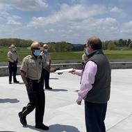 Commissioner Woods reaches out to hand a new Ranger a certificate ke