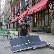 Irwin Edwards sets up their new accessibility ramp at Elephant & Castle in downtown Boston. (Mayor's Office Photo by John Wilcox)