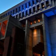 Lights are visible at night on Boston City Hall