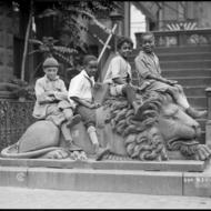 South End kids pose on stone lion, 511 Columbus Ave. 