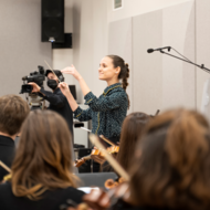 Opportunity Fund grantee Sheila de Bosque Fuentes conducting an orchestra