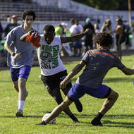 Three soccer players on the field at White Stadium 